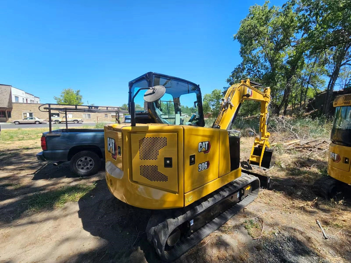 Rear view of used CAT 306 compact excavator after container delivery New York port